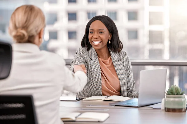 stock image I cant wait to see the new direction. a young businesswoman shaking hands with a fellow staff member