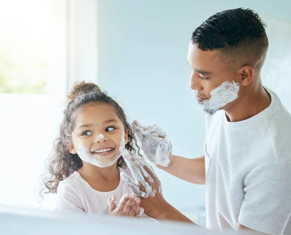 Nothing is more precious than a fathers love. a little girl and her father playing around with shaving cream in a bathroom at home