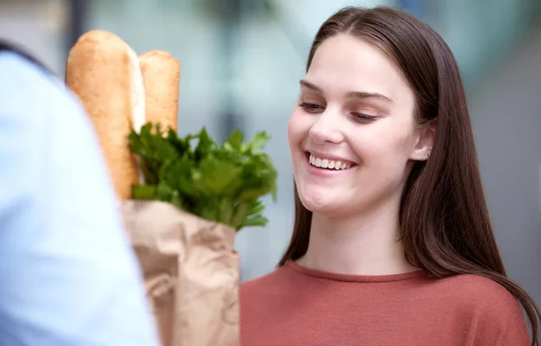 So grateful for online deliveries. a young woman receiving her grocery delivery