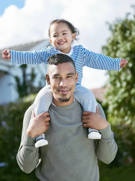 Family is everything to me. a young man carrying his daughter on his shoulders