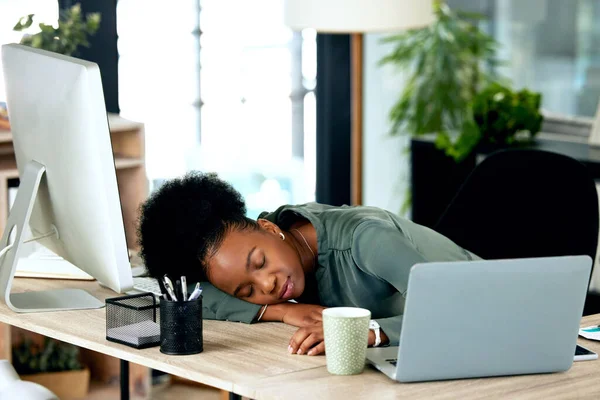 Power naps are helpful for productivity. a young businesswoman taking a nap at work