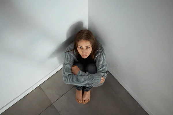 Depressed Young Woman Sitting Corner Alone — стоковое фото