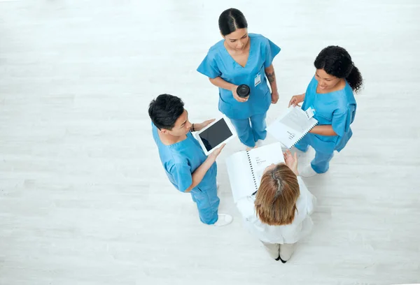 The bond of lifesavers. Above shot of a group of medical practitioners having a discussion in a hospital