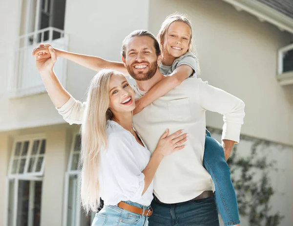 Its not about the house you live in but the love in it. a couple and their two children standing together outside