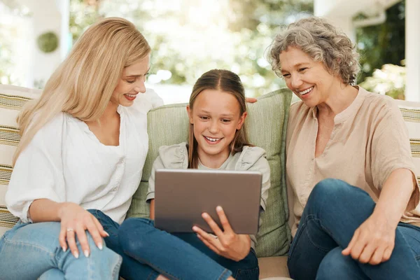 Technology brings family together. a grandmother spending time with her daughter and granddaughter while using a digital tablet