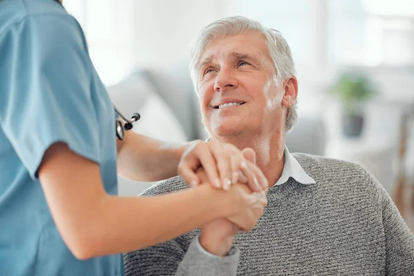 Its scary, but she makes it better. an unrecognizable doctor offering their patient support in a hard time