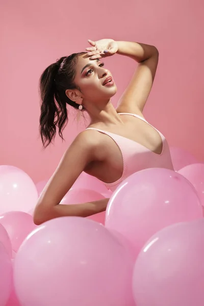 Paint me like one of your french girls. Studio shot of a beautiful young woman posing with balloons