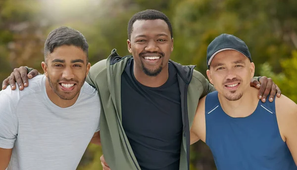 Fitness is life. Portrait of a group of sporty young men standing together in a huddle while exercising outdoors