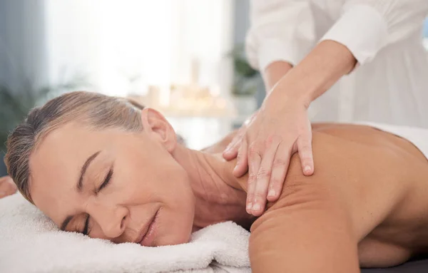 Take a deep breath and put your wellbeing first. mature woman enjoying a relaxing back massage at a spa