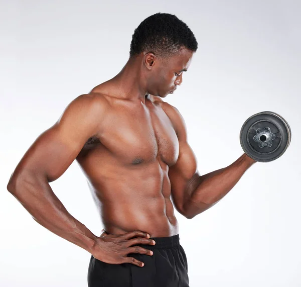 Heres Bigger Arms Young Man Standing Alone Studio Using Dumbbell — Foto de Stock