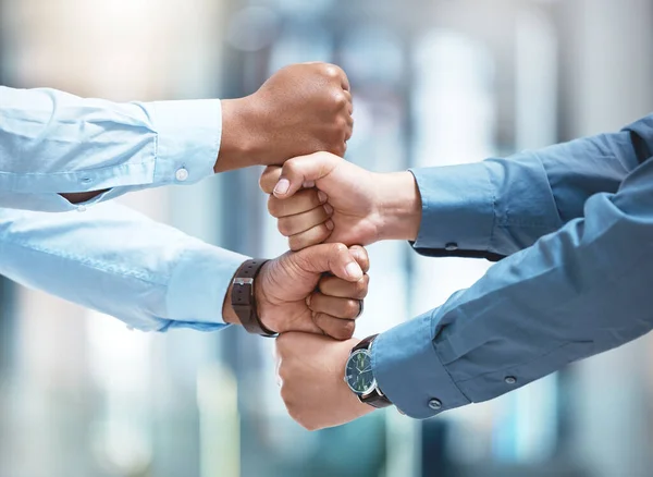 No letting go, no holding back. two unrecognizable businesspeople stacking their fists outside