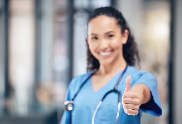 Always stay positive. a young female doctor showing a thumbs up at a hospital