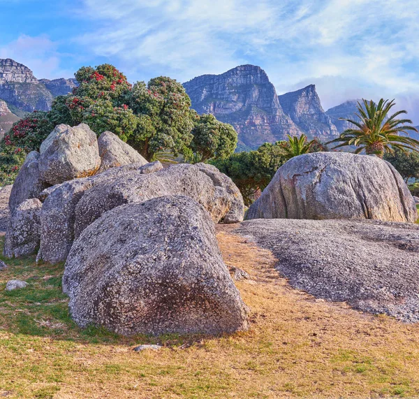 Rocks Boulders Majestic Mountain Background Lush Green Trees Clear Blue — Stockfoto