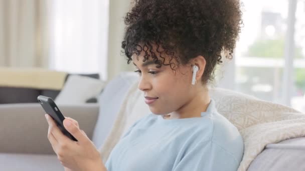 African Woman Browsing Social Media Her Phone Listening Music Earbuds — Vídeo de stock
