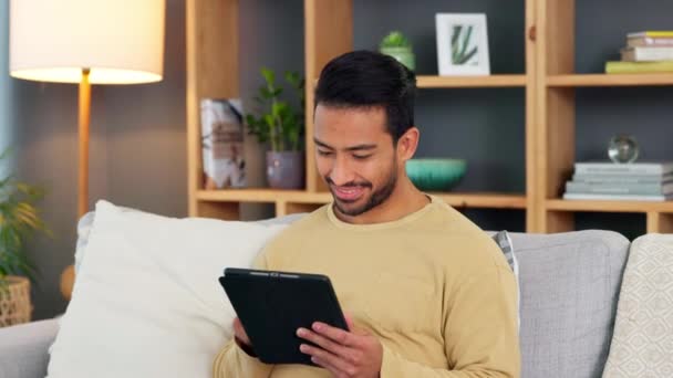 Young Man Browsing Digital Tablet Sofa Home Happy Guy Smiling — стоковое видео