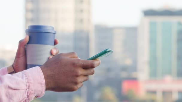 Close Hand African American Person Scrolling Phone Holding Cup Blurred — Video Stock