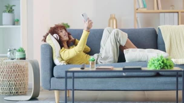 Woman Taking Selfies Social Media While Listening Music Relaxing Sofa — стоковое видео