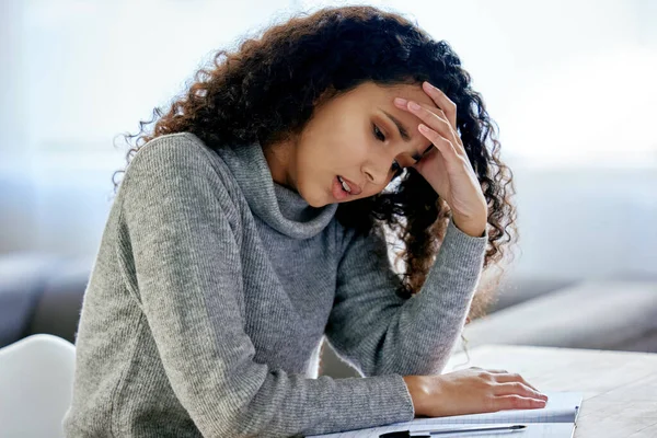 The secret of success is to do the common things. a young woman looking stressed while working from home