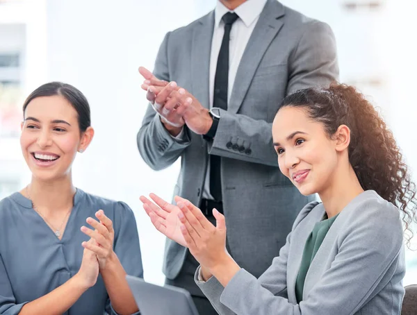 Give props where its due. a group of business people applauding during a meeting