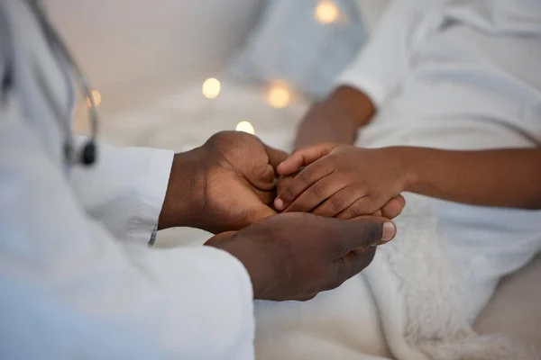 Youll feel better in no time. an unrecognizable doctor holding a patients hand at a hospital