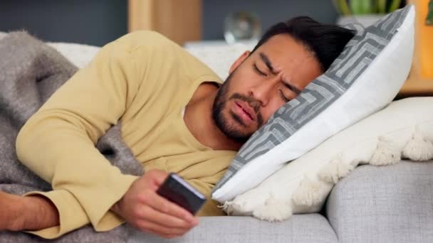 Sick Guy Using Phone Wrapped Blanket Lying Sofa Suffering Fever — Vídeos de Stock