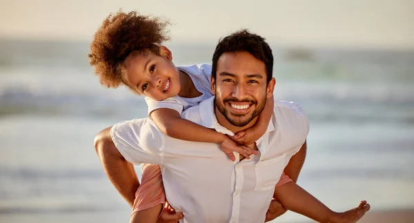 Home is where you are loved the most. a father carrying his daughter at the beach