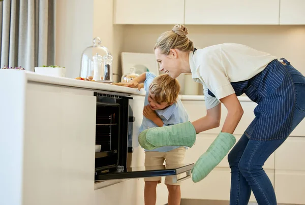 Do you think its ready. a young mother and son cooking together at home