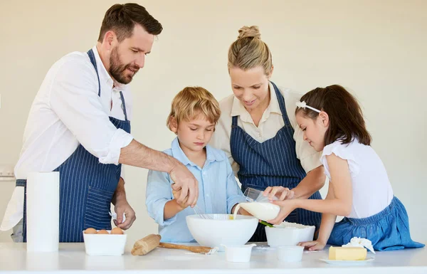 Youre doing a great job. a young family cooking together at home