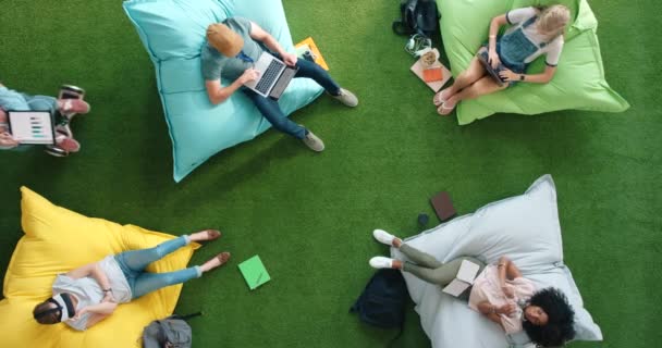 Aerial View Designers Using Smart Technology While Relaxing Bean Bags — Vídeo de stock