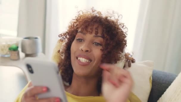 Cheerful African Woman Using Phone Wearing Headphones Listening Music While — Stok Video