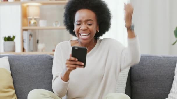 Happy African American Woman Expressing Joy Winning Gesture While Holding — ストック動画