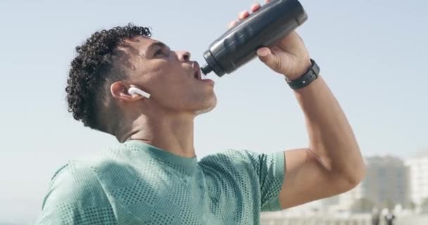 Video Footage Man Wearing Earpods Drinking Water While Out Run — Stockvideo
