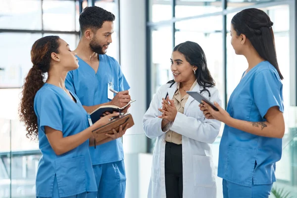 Medicine cure diseases but only doctors can cure patients. a group of medical practitioners having a discussion in a hospital