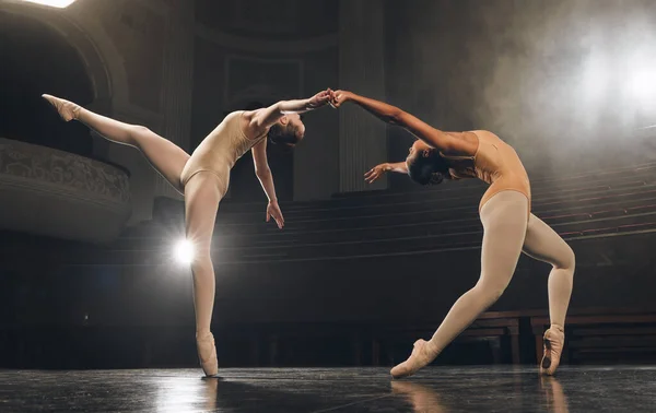 Dancing is the poetry of the foot. a group of ballet dancers practicing a routine on stage