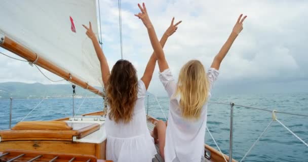 Carefree Young Women Making Peace Signs Cruise Sitting Boat Two — Vídeos de Stock