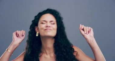 4k video footage of a young woman dancing against a grey background.