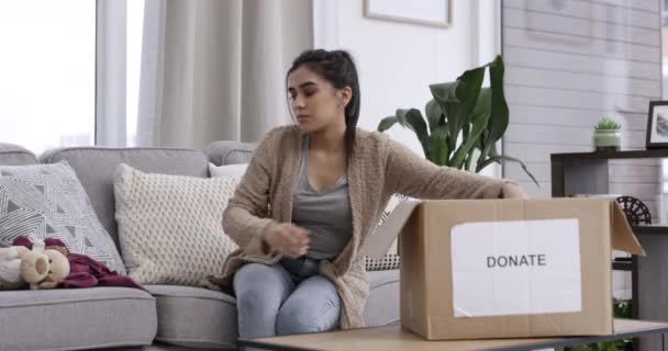 Video Footage Woman Packing Items Donation Box Home — Stockvideo