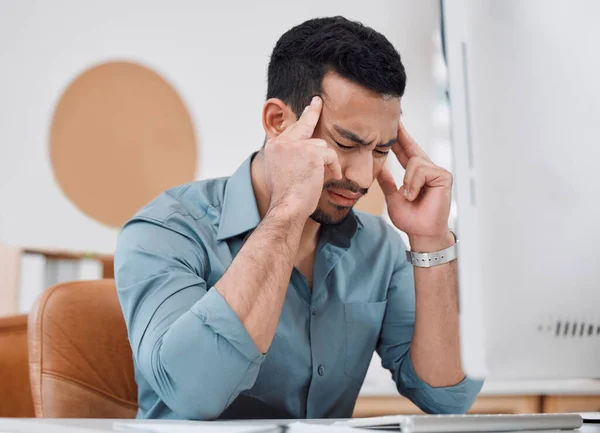 I wish these deadlines would complete themselves. a young businessman looking stressed out while working on a computer in an office