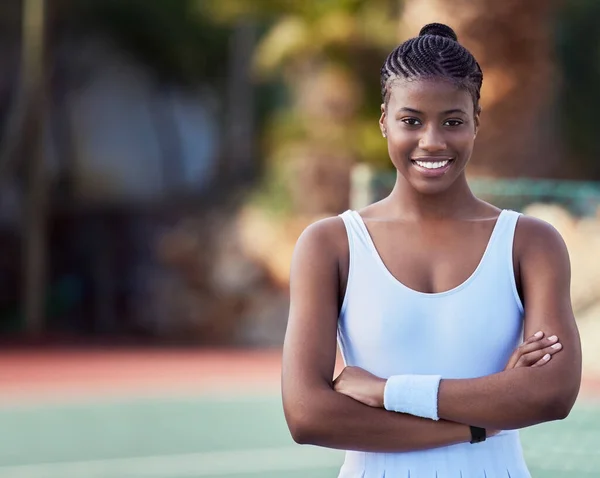 Never give up, never give in. an attractive young woman standing alone on a tennis court