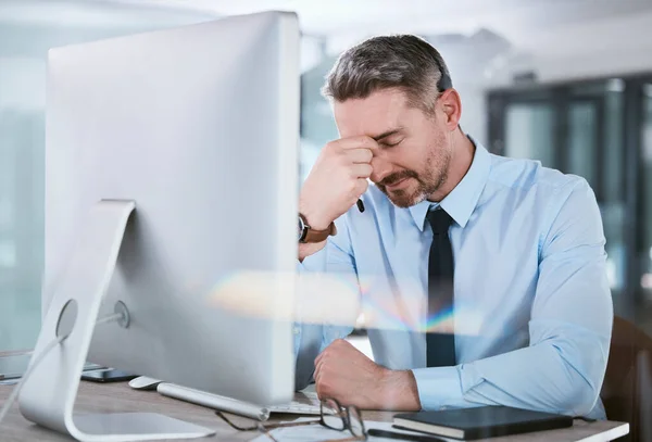 My shot at success is hindered for today. a mature call centre agent looking stressed out while working on a computer in an office