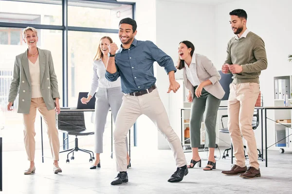 Dance the stress away. Full length shot of a diverse group of businesspeople standing together and dancing in the office