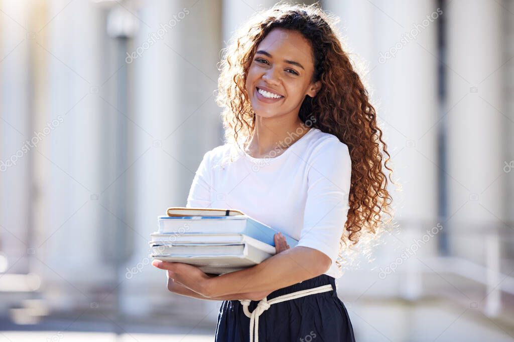 Happiness is a journey, not a destinatio. a young woman carrying her schoolbooks outside at college