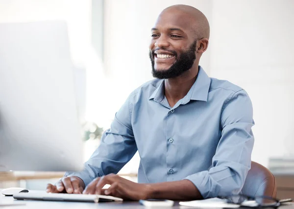 Hes making progress. a handsome young businessman working on his computer in the office