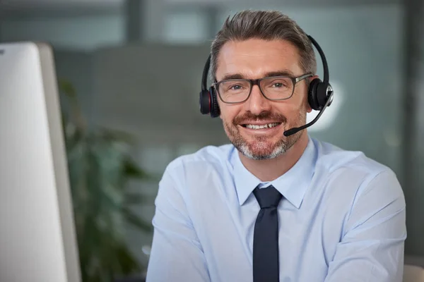 Your work ethic will get you further than your qualifications. Portrait of a mature male call center agent working in a modern office