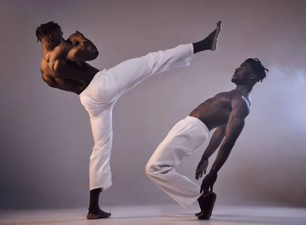 Strength does not come from the physical capacity. two men fighting against a grey background