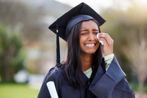 She cant hold back the tears. an attractive young female student crying while while celebrating her graduation day