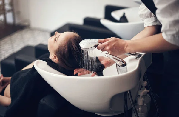 Theres nothing more relaxing than getting your hair washed at the salon. a beautiful young woman getting her hair washed at the salon