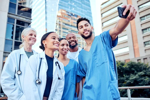 These doctors deserve a break. a group of doctors taking a selfie in the city