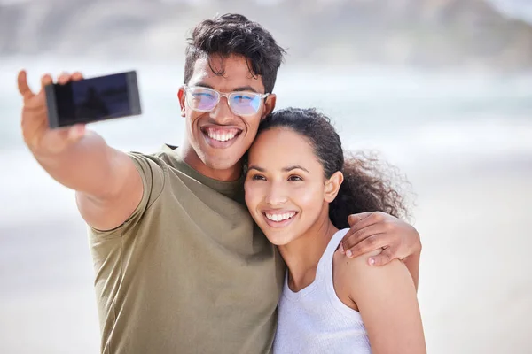 We make new memories every day. a young couple taking a selfie at the beach