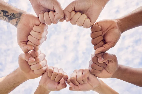 Life gets better when we live it together. a group of unrecognizable people joining their hands in solidarity